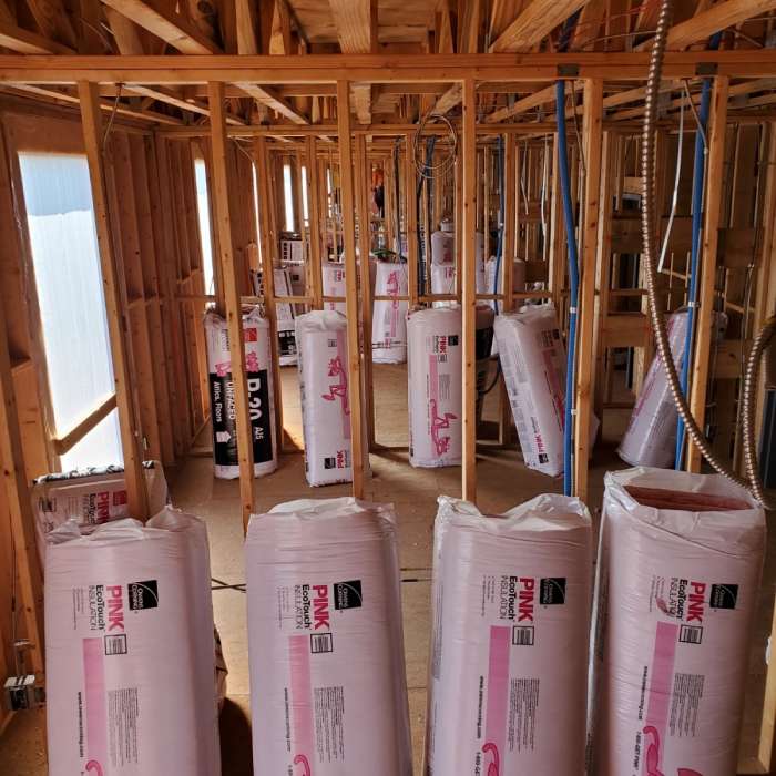 Packaged fiberglass batt insulation in a new construction, prior to be installed